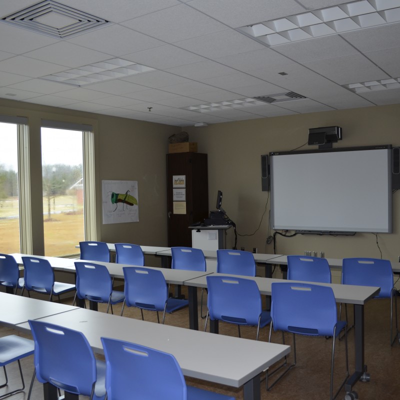 a classroom with several chairs and desks