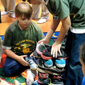 two boys stacking shoes