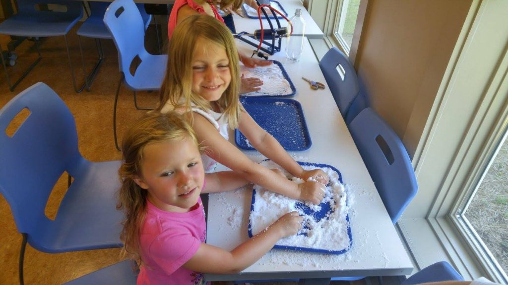 two girls playing with flour