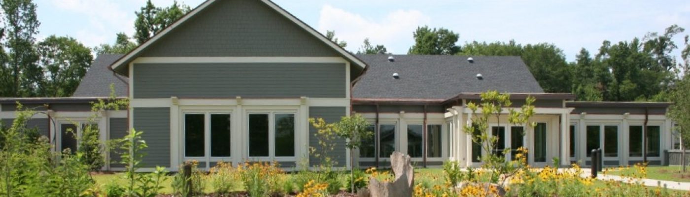 a gray building surrounded by trees