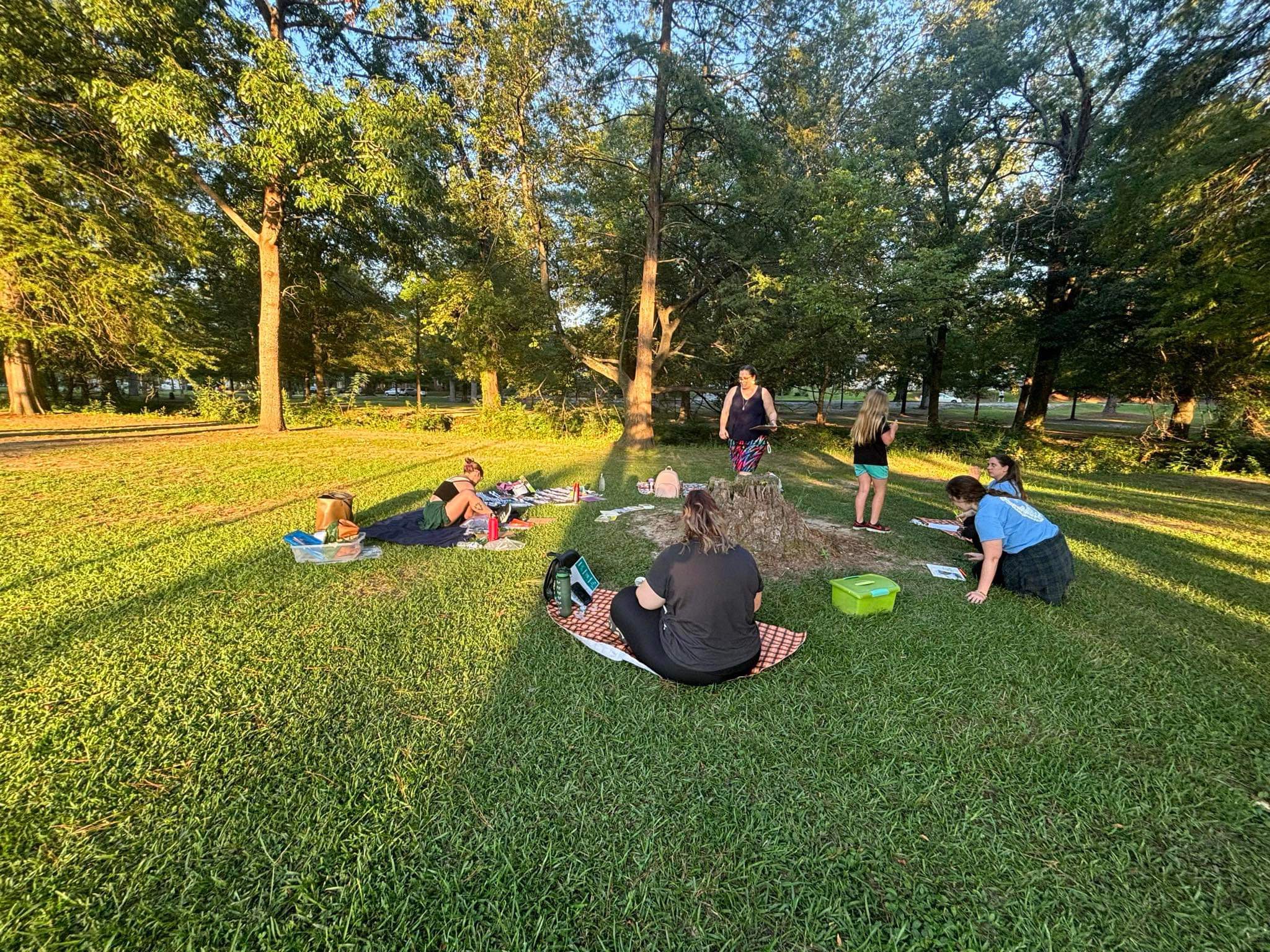 People sittingaround stump