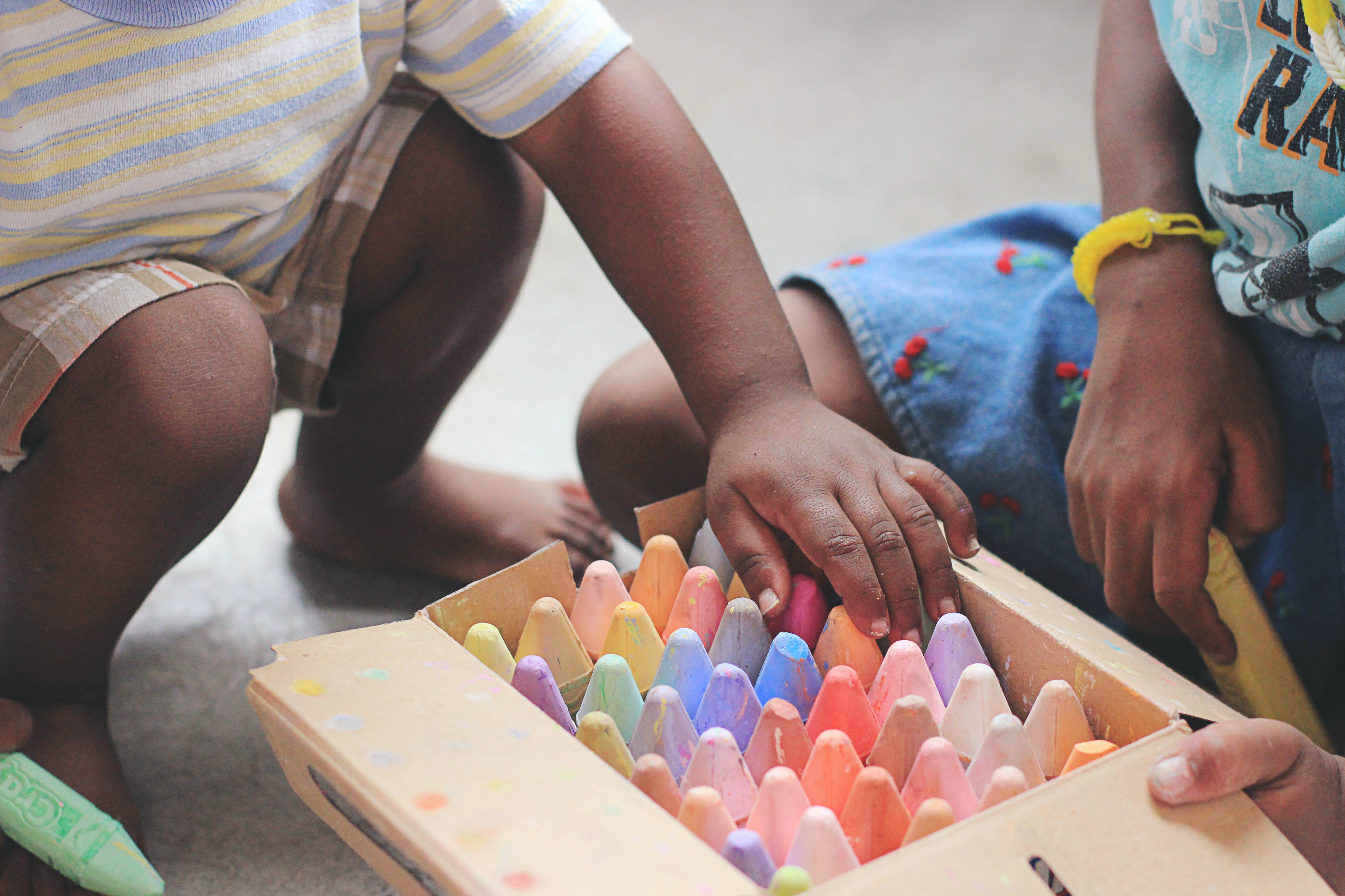 Child hand reaching for chalk